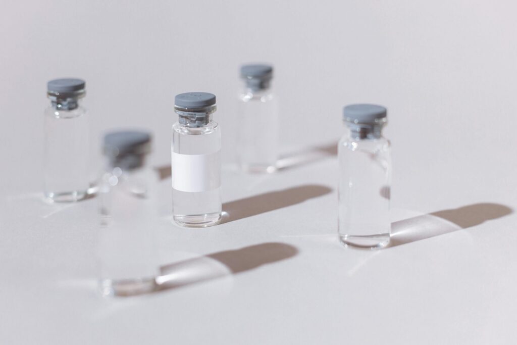 Small glass bottles with clear liquid