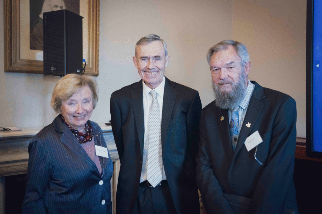 Kathryn Greiner AO, His Honour Anthony Parsons, and Adjunct Professor Scott Wilson stand together in front of a white background.